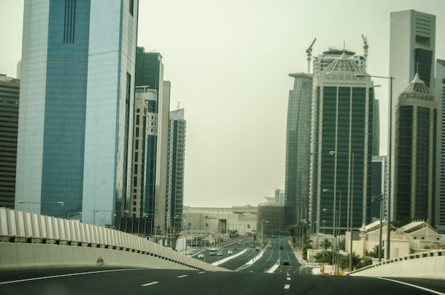 Photo the landscape of doha areal view of the west bay city skyline in the evening qatar middle east