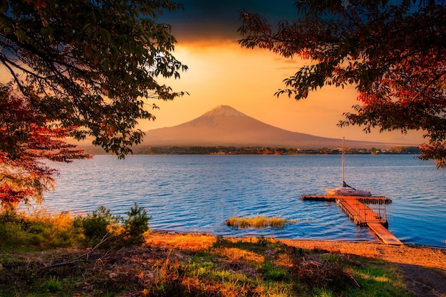 Landscape image of Mt Fuji over Lake Kawaguchiko with autumn foliage at sunset in Fujikawaguchiko Japan