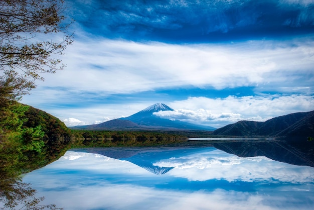 Landscape image of Mt Fuji over Lake Motosu with autumn foliage at daytime in Yamanashi Japan