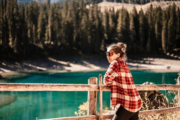 Landscape of Lake Carezza Karersee with Dolomites Nova Levante Bolzano Italy Majestic landscape of Alpine red autumn Lake Carezza Wonderful hiking nature scenery in dolomites