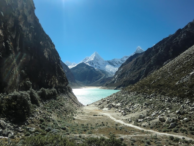 Landscape of a lake between snowy peaks in the mountains of Peru