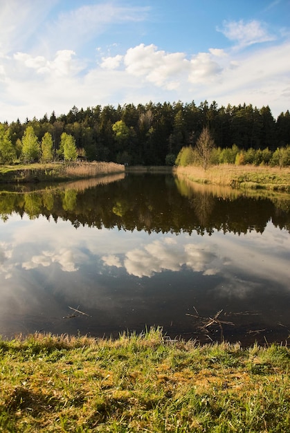 landscape of lakes and forests. the sky is reflected in the water. the clouds. the sun