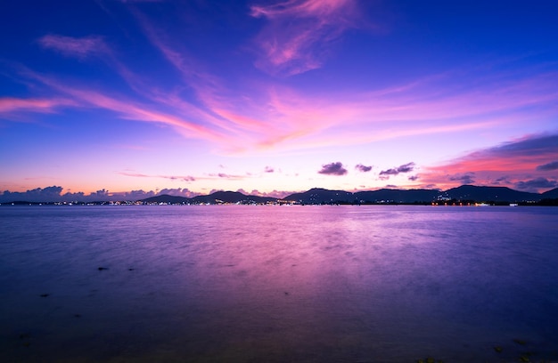 Landscape Long exposure of majestic clouds in the sky sunset or sunrise over sea with reflection in the tropical seaBeautiful cloudscape sceneryAmazing light of nature Landscape nature background