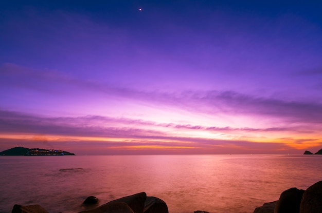 Landscape Long exposure of majestic clouds in the sky sunset or sunrise over sea with reflection in the tropical seaBeautiful cloudscape sceneryAmazing light of nature Landscape nature background