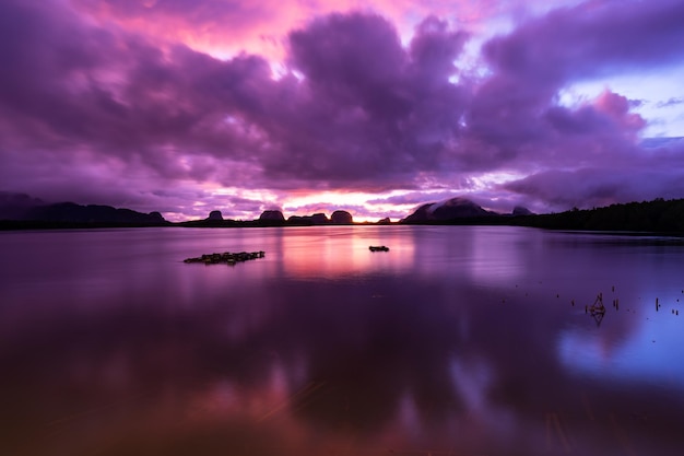 Landscape Long exposure of majestic clouds in the sky sunset or sunrise over sea with reflection in the tropical seaBeautiful cloudscape sceneryAmazing light of nature Landscape nature background