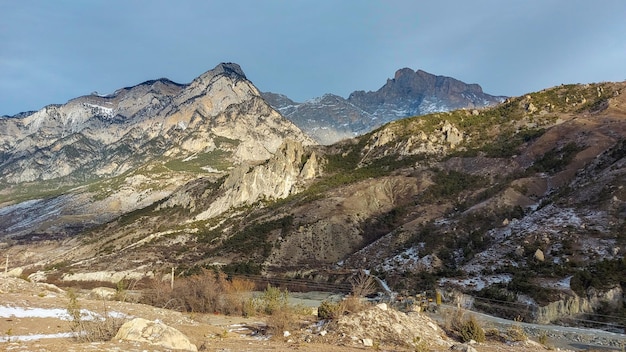 Landscape of mountains Stunning gloomy bird'seye view of a high snowy mountain peak