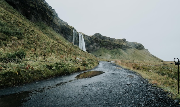 Landscape of the Seljalandsfoss waterfall in Iceland during a moody day Travel on van concept road trip style Visit Iceland and north countries concept