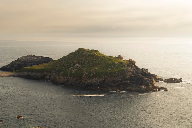 Landscape of a small island on the sea in a sunset with clouds. Peace and quiet concept.