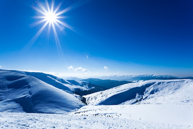 Landscape of snow winter valley and mountains on sunny day