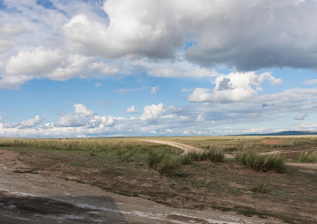 Landscape steppe Tyva The road near the lake DusKhol Sunny day Beautiful clouds