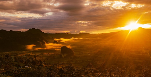 Landscape sunrise over mountains and warm morning sun