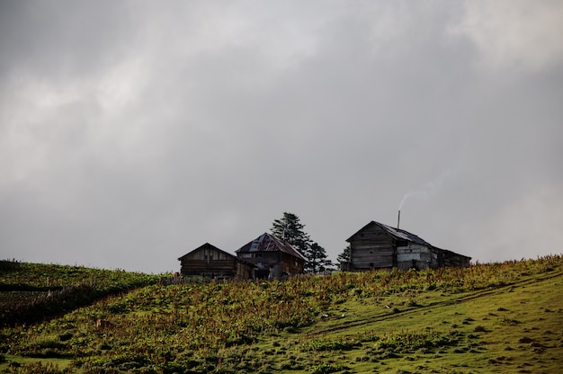 Landscape of the three wooden houses on the hill