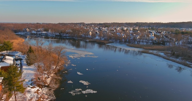 Landscape view the shore the river floating ice drifting floes on view of the small town in resident