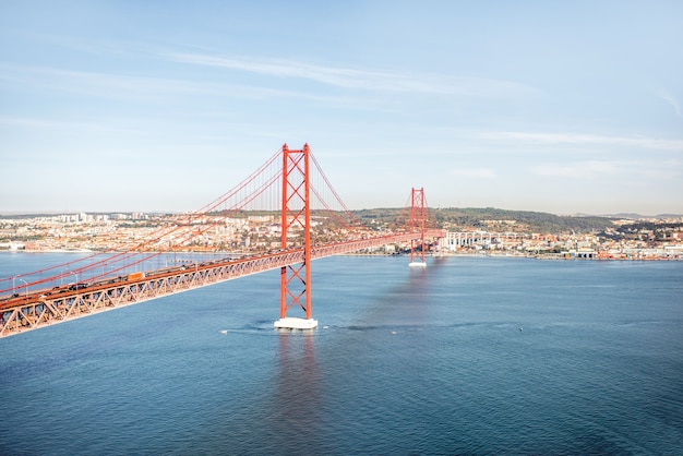 Landscape view on the Tagus river and the famous 25th of April Bridge during the morning light in Lisbon city, Portugal