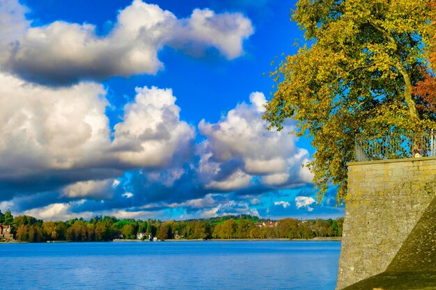 Landscape view with stone wall and blue lake cloudy sky