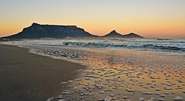 Landscape with the beach in Milnerton and Table Mountain at sunrise