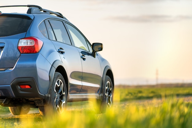 Landscape with blue off road car on gravel road. Traveling by auto, adventure in wildlife, expedition or extreme travel on a SUV automobile.