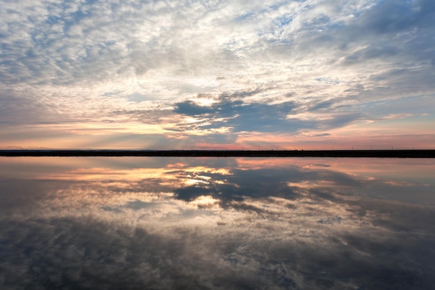 Landscape with lake reflection clouds Beautiful summer sunset