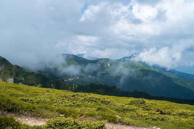 Landscape with mountains and clouds. Rocks. Hiking tourist destination