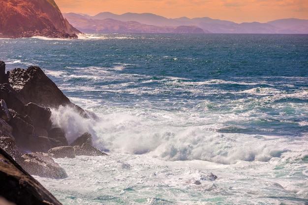 Landscape with sea and cliffs Rocky seashore on a sunny day Beautiful nature landscape stormy sea San Sebastian Basque Country Spain Europe