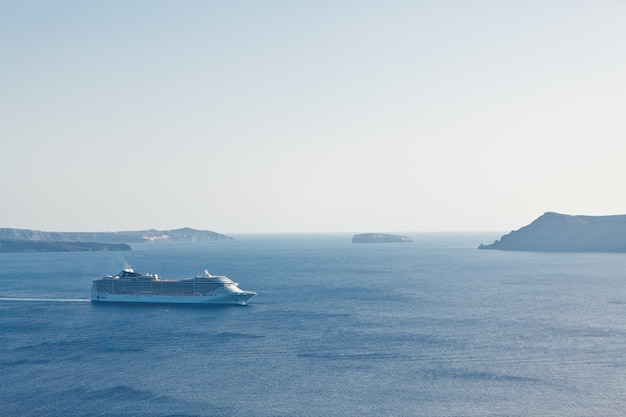 A landscape with sea view. Cruise liner at the sea near the island Santorini, Greece