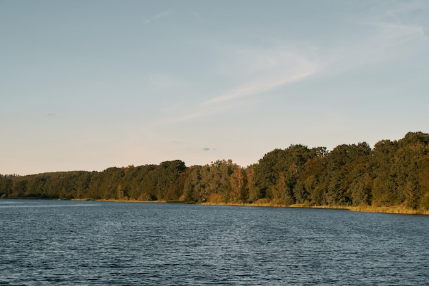 Landscape with sunset over lake Evening sky over water during summer