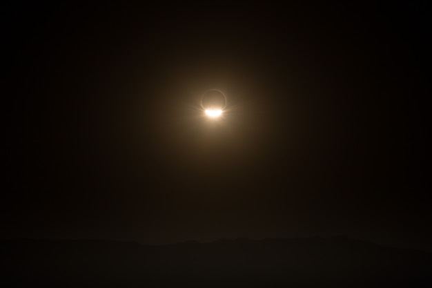 Landscape with total eclipse of so, over the mountains