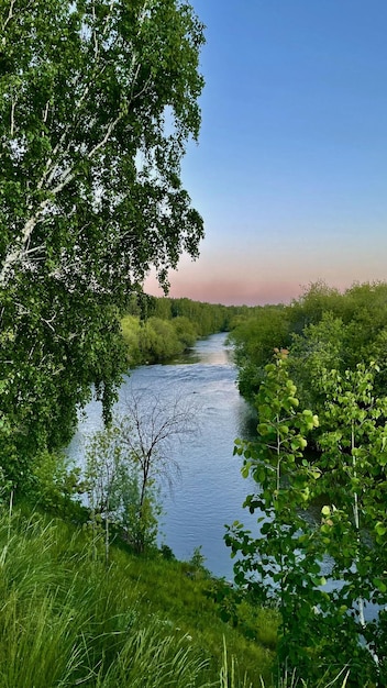 A landscape with a view of the river and the sunset