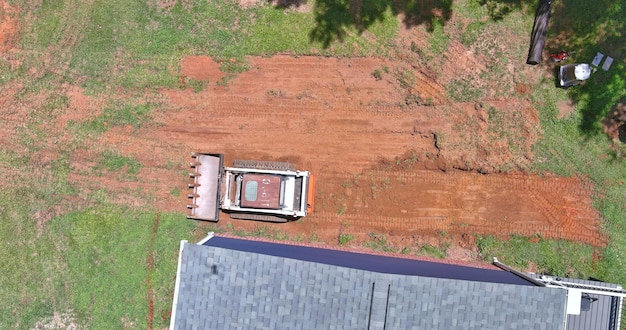 During landscaping works a bulldozer is used to move earth with the scoop that is attached to it