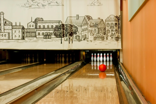 lane in a bowling club with a rolling ball and pins