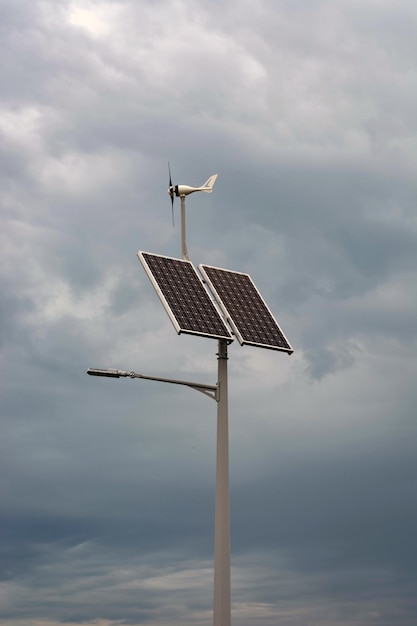 Lantern with a lantern and installed solar panels on blue sky