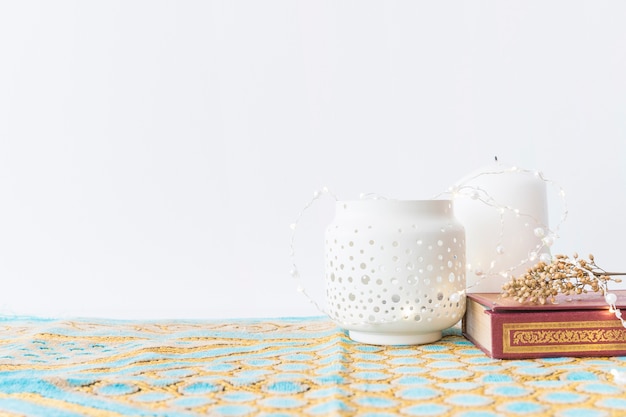 Lanterns and Koran with flowers 