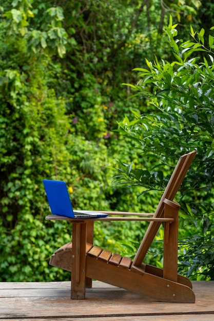 A laptop on a Adirondack chair in a rainforest lodge digital nomad concept Chiriqui Panama