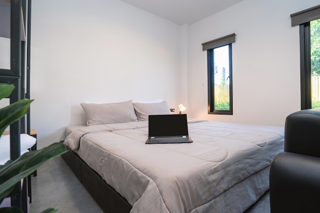 Laptop over a bed in a modern bedroom