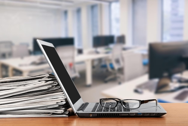 Laptop and black glasses  on   background.