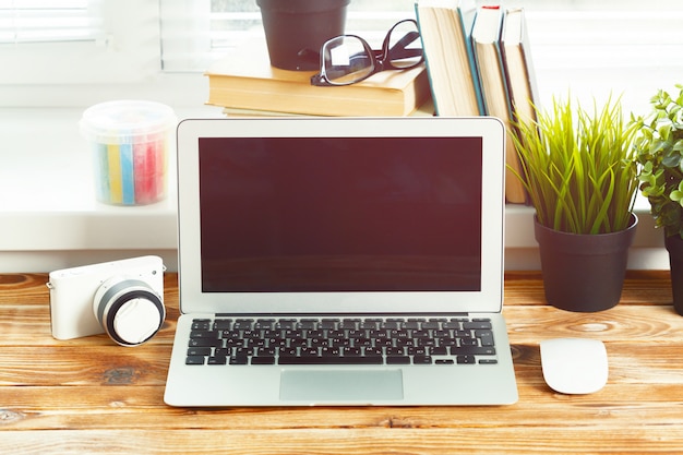 laptop blank screen on wooden table,