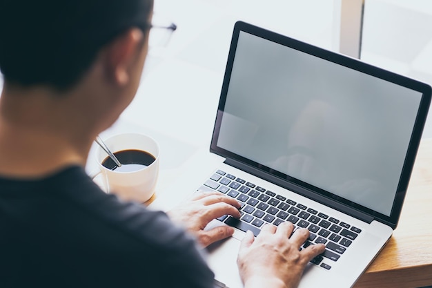 Laptop in businessman hand with coffee