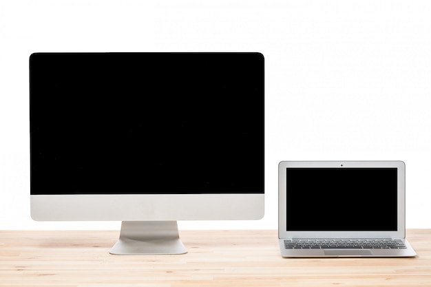 Laptop computer and big computer monitor display on light wooden table