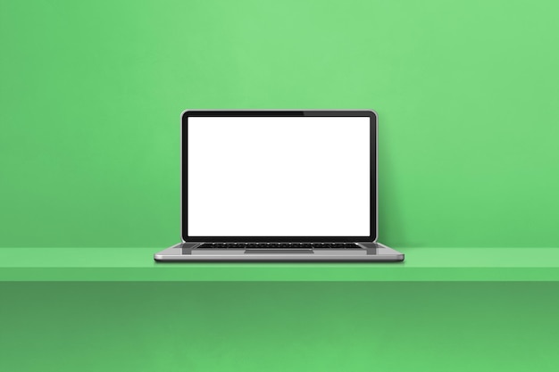 Laptop computer on green shelf background