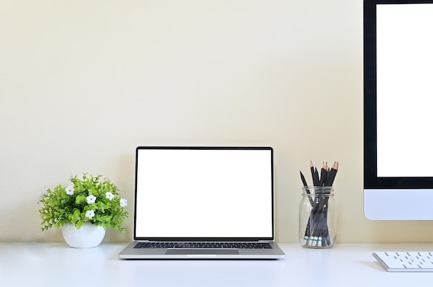 Laptop computer and PC on office desk, Workspace with mockup.