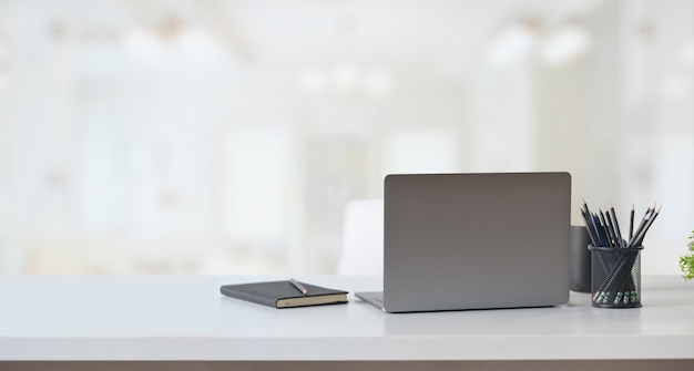 Laptop computer on table in office workspace.