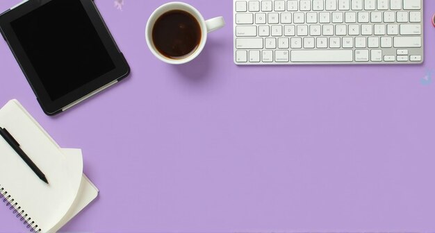 a laptop and a cup of coffee sit on a purple table