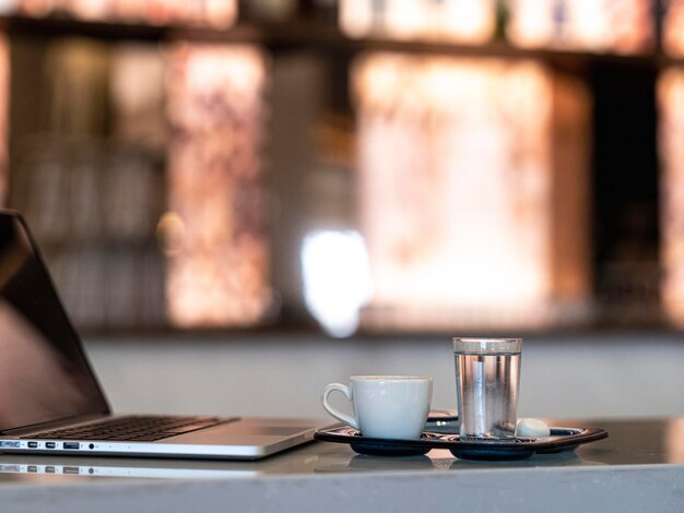 A laptop and a cup of Turkish coffee