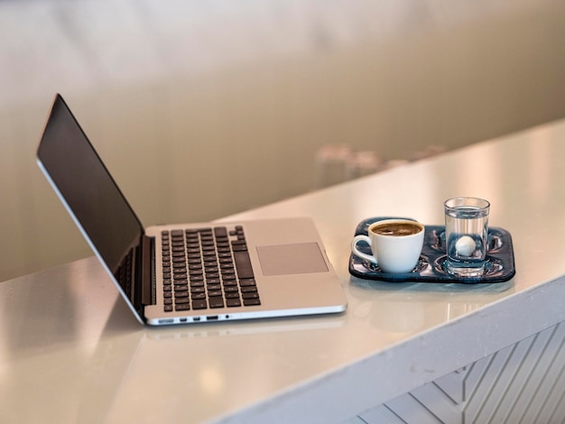 A laptop and a cup of Turkish coffee