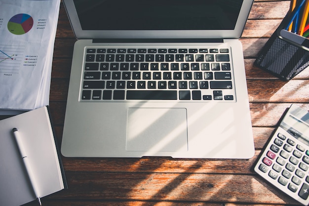 Laptop on the desk of business stylists vintage hipster. 