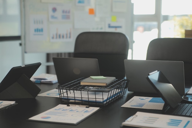 Laptop on a desk in an open financial office