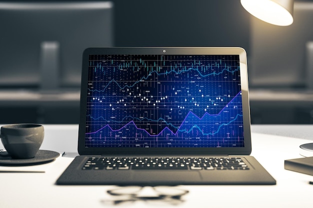 Laptop on desk with chart on screen