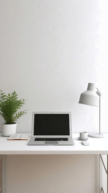 A laptop on a desk with a plant next to it