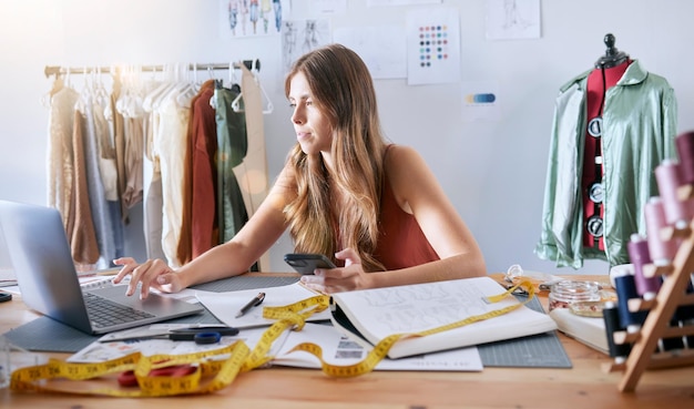 Laptop fashion and woman designer working on an online design with technology in a workshop Creative tech and female small business owner planning a clothing collection on a computer in her studio