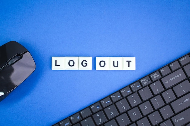 laptop keyboard and mouse with the alphabetic word log out. concept of logging out of an account